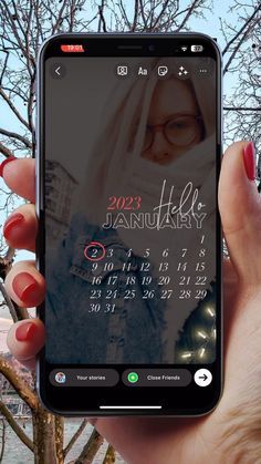 a person holding up a cell phone with the calendar on it