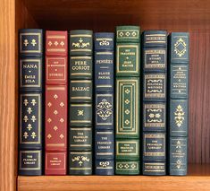 a row of old books on a wooden shelf