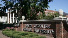 the sign for north carolina central university in front of a brick building with columns and pillars