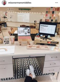 someone sitting at a desk with their feet on the keyboard and computer monitor in front of them