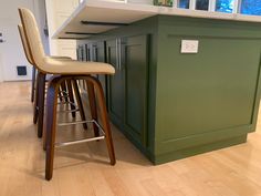 a kitchen island with stools next to it