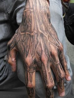 a man's hand with an intricate pattern on it