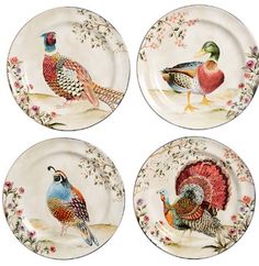 four plates with different colored birds on them