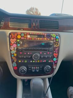 the dashboard of a car decorated with hearts and peace signs on it's dash board