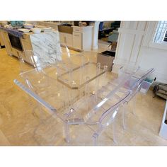 a clear table and chairs in a room