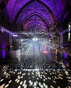 an image of a stage set up for a party with lights on the floor and disco balls in the air