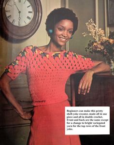 a woman in a red dress standing next to a clock