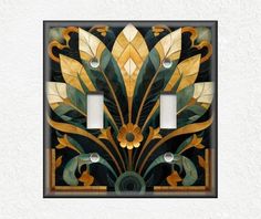 an art deco light switch plate cover with gold and green leaves on it, in the shape of a flower