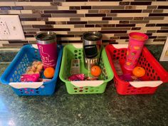 three plastic baskets filled with food on top of a kitchen counter next to a tile backsplash