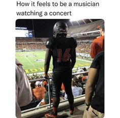 a football player standing on top of a field next to an empty bleachers