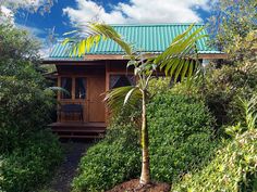 a wooden house surrounded by trees and bushes