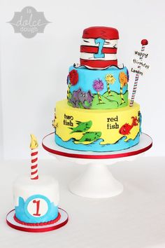 two tiered cake decorated with dr seuss and the cat in the hat theme