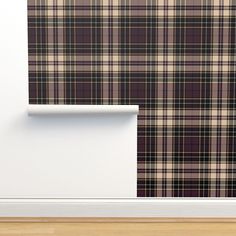 an empty room with plaid wallpaper and wooden flooring