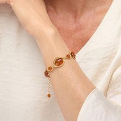 Elevate your style with the Amber Extraordinaire Gold-Plated Sterling Silver Oval Station Bracelet. This exquisite piece showcases the warm, radiant hues of pressed Cognac Baltic Amber, set in beautifully textured, sun-kissed silverwork. Each link of this bracelet captures the essence of modern elegance, making it a perfect accessory for enhancing your outfits with a touch of enchantment.

- Size: Available in S/M (approx. 6-1/4"L; fits 6-1/4" to 7-1/4" wrist) and M/L (approx. 6-3/4"L; fits 6-3/ Elegant Oval Amber Bracelets, Adjustable Citrine Jewelry, Luxury Adjustable Oval Bracelets, Elegant Orange Gemstone Bracelet, Elegant Amber Bracelets For Formal Occasions, Elegant Adjustable Citrine Bracelets, Elegant Amber Citrine Bracelet, Station Bracelet, Amber Gemstone