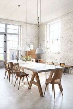 a dining table with six chairs in an open room