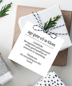 a gift wrapped in black and white paper with a note that says appreciation on it