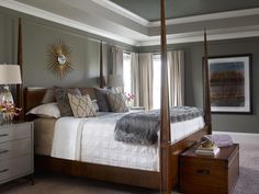 a bedroom with a four poster bed and dresser