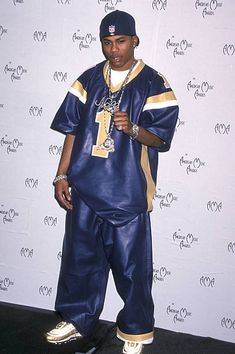 a man in blue and gold outfit standing next to a wall