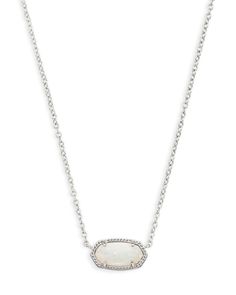 A dainty stone and delicate metallic chain combine to create the Elisa Silver Pendant Necklace in White Kyocera Opal, your new favorite wear-anywhere accessory (and one of our October birthstones!). This pendant necklace can be paired with any look, providing that extra touch of timeless style. Make the Elisa Pendant Necklace a staple in your wardrobe and you will not be disappointed. • Metal: Silver Plated Over Brass • Size: 0.63"L x 0.38"W stationary pendant, 15" chain with 2" extender • Material: White Kyocera Opal Material Highlight: Kyocera Opal Our Kyocera Opal is a lab grown, stabilized opal created to mimic the dazzling structure of natural opal. Beautifully reflective and never dyed, this stone takes 12-14 months to produce and is best loved for its striking flashes of colored lig Kendra Scott Jewelry Silver, Popular Necklaces 2024, Silver Kendra Scott Necklace, Jewelry Silver Necklaces, Cute Silver Necklaces, Kendra Scott Necklace Silver, Simple Silver Necklace, Silver Kendra Scott, Useless Things