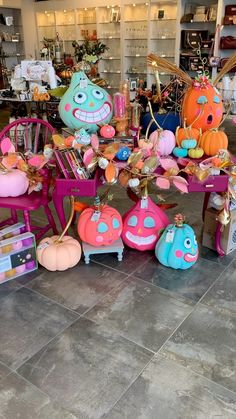 there are many stuffed animals on display in the store, including pumpkins and other decorations