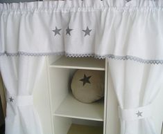 a white curtain with stars hanging from it's side