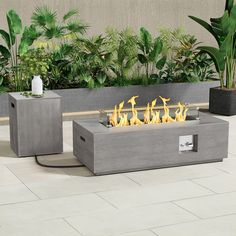 an outdoor fire pit sitting next to two planters