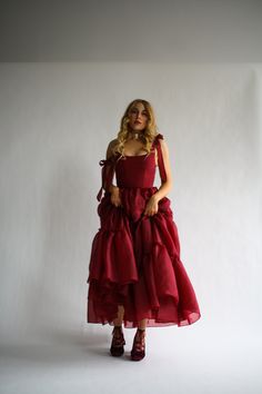 Our signature Siena silhouette: now in a full length gown version. The Siena gown features floor length three tier dress in the perfect shade of dark cherry red for the ultimate romantic look. The bust features V shaped corset boning that gives a flattering look. Corset Floor Length Dress, T Length Prom Dress, Fantasy Inspired Dresses, Red Tiered Dress, Art Inspired Outfits, How To Style Red Dress, Romantic Dress Aesthetic, Little Red Dress Outfit, Berry Gown