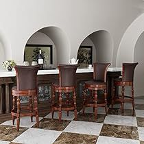 a dining room table and chairs with marble flooring in front of an arched wall