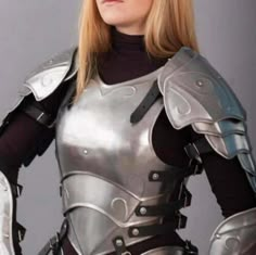 a woman dressed in armor posing for a photo