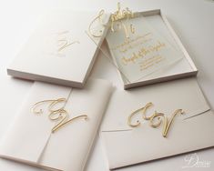 three wedding cards with gold lettering on them