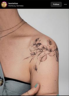 a woman's shoulder with flowers on it