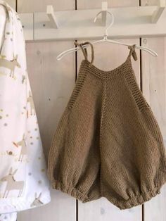 a brown knitted romper hanging on a clothes line