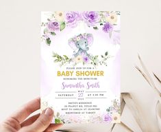 someone holding up a baby shower card with flowers and an elephant in the middle on it