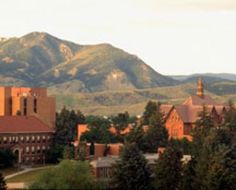 the mountains are in the distance behind this building