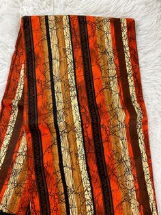 This African Fabric is high quality African print made from 100% cotton and it's 45 inches wide. It is used for making African Clothing, African quilts, & For Home decoration. FYI: Print is Double sided. The listing is for 1, 6 yards and Headwrap Each piece of fabric measures:  36in by 45in for 1 yard 216in by 45in for 6 yards 70in by 22in for Head wrap If you purchase more than one yard, you will receive one continuous piece. *If you require more than what I have listed, feel free to send me em Brown Ankara Fabric With Batik Print, Traditional Brown Ankara Fabric, Orange Ankara Fabric With Batik Print, Ankara Fabric With Abstract Pattern, Traditional Brown Cotton Fabric, Printed Orange Ankara Fabric, African Quilts, Clean And Press, Kitenge