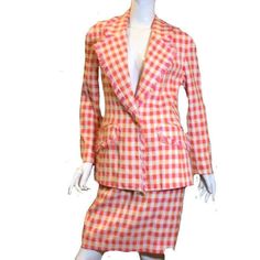 Ungaro 80s Gingham Two Piece Suit Size 10 Vintage 1980s Ungaro gingham plaid suit is a great representation of the 1980s.  The plaid textile Is made up of pinks and oranges set on a winter white background.  Double breasted jacket  has full padded shoulders with a silhouette that creates a defined waist and two front pockets.  The jacket's V neckline is decorated with fringe that goes down the iron and decorates the two front pockets A-line skirt is form fitting and has a vent in the back for easy movement.  The jacket and skirt is made up of 37% rayon, 39% wool, and 24% cotton. Jacket and skirt are fully lined in 100% rayon.  Condition for this Ungaro suit is excellent.  Approximate Measurements for Jacket: Pit to Pit: 38" Waist: 34" Hips: 38" Sleeve Length: 28" Length: 22 1/2" Suit Skirt Fitted Long Sleeve Plaid Sets, Fitted Plaid Sets For Spring, Fitted Gingham Sets For Spring, Retro Workwear Sets For Spring, Retro Spring Workwear Sets, Fitted Plaid Blazer For Spring, Spring Fitted Plaid Blazer, Pink Skirt Suit For Spring Office Wear, Gingham Two Piece