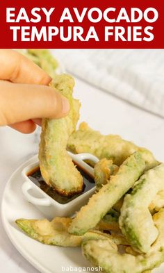 someone dipping sauce on some fried food in a small container with the words easy avocado tempura fries