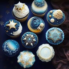 there are many cupcakes decorated with blue and white icing