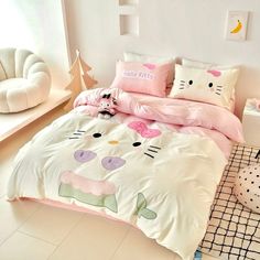 a bed with hello kitty comforters and pillows