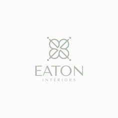 the eaton interiors logo is shown in green and gray colors, with an elegant flower design on