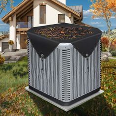 an air conditioner in front of a house with autumn leaves on the grass and trees