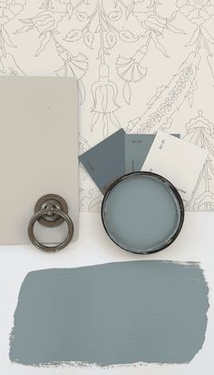 the paint is being used to create an elegant wallpaper design with blue and gray tones