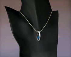 "London Blue Topaz and White Sapphire Necklace - Argentium Silver - 3418 - Argentium chain Included Make a statement with this contemporary design handcrafted by award winning designer, David Worcester. ( IMPORTANT - PLEASE READ 1. AND 2 BELOW ) 1.) INCLUDED IN THE PRICE IS AN ARGENTIUM SILVER CHAIN APPROPRIATE FOR THE PENDANT CHOSEN. YOU CAN CHOOSE FROM 16\", 18\" OR 20\" AT CHECKOUT. 2.) PLEASE LOOK AT THE MEASUREMENTS CAREFULLY. SOME PHOTOS HAVE BEEN ENLARGED TO SHOW DETAIL, WHILE OTHERS HAVE Modern Necklace With Diamond Cut For Gifts, Modern Diamond Cut Necklace As A Gift, Modern Necklaces With Diamond Cut For Gifts, Modern Hallmarked Pendant Necklaces, Modern Hallmarked Pendant Necklace, Fine Jewelry Pendant Necklace With Tension Setting, Modern Blue Necklace With Polished Finish, Modern Blue Necklaces With Polished Finish, Silver Sapphire Necklace With Polished Finish