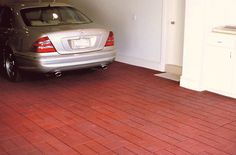 a car is parked in the garage with its door open