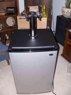 a silver and black refrigerator freezer sitting in a room