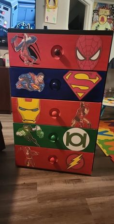 a colorful dresser with superman stickers on it