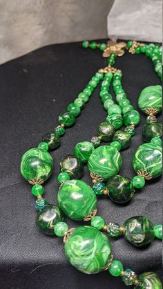 FREE SHIPPING- Vintage Multi Strand Necklace with Gold Tone Accents and Marbled Faux Jade Green Beads. See Item Description for Important info! Great Condition& Vibrant Greens~! There is a Maker's Mark signature under the Hook on the Butterfly, but it is hard to make out. FREE SHIPPING FOR ALL ORDERS GOING TO THE CONTINENTAL U.S.A (LOWER 48 STATES) ALL PURCHASES DESTINED FOR ALASKA OR HAWAII WILL INCUR SHIPPING CHARGES PLEASE SEE OUR PHOTOS ABOVE FOR DETAIL & CONTACT US WITH ANY QUESTION Vintage Polished Beads For Jewelry Making, Vintage Beaded Necklaces With Colorful Beads, Vintage Large Beads For Jewelry Making, Vintage Beads And Cabochons For Jewelry Making, Vintage Round Beads For Jewelry Making, Vintage Beaded Chain Necklace With Round Beads, Large Vintage Beads For Jewelry Making, Handmade Retro Green Beaded Necklace, Vintage Round Bead Necklaces Collectible