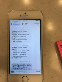 an iphone sitting on top of a table next to a red box with writing on it