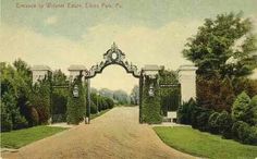 an old postcard shows the entrance to a large garden with trees and bushes on either side