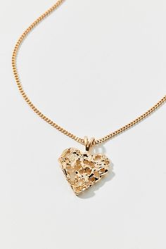 This delicate chain necklace is trimmed with a heart pendant complete with a textured finish. Features Textured metal heart necklace Delicate chain necklace Textured heart pendant Adjustable lobster clasp Content + Care Mixed metal Avoid contact with water Imported Size Dimensions: 16" l + extender | Textured Metal Heart Charm Necklace in Gold, Women's at Urban Outfitters Heart-shaped Metal Charm Necklaces With Delicate Chain, Heart Shaped Metal Necklace With Delicate Chain, Heart-shaped Metal Necklace With Delicate Chain, Gold Necklace From Urban Outfitters As A Gift, Urban Outfitters Gold Necklace As A Gift, Metal Heart Necklace With Delicate Chain, Heart Charm Necklace, Metal Heart, Delicate Chain